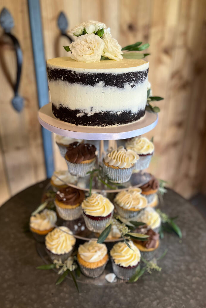 Semi naked wedding cake with cupcakes Semi naked wedding cake with cupcakes